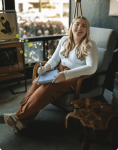 Katy therapist is sitting on a sofa in a calm therapy office space.