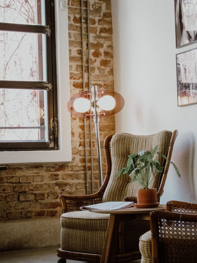 Sunlit cozy armchair by a brick wall in a vintage interior, Istanbul setting.