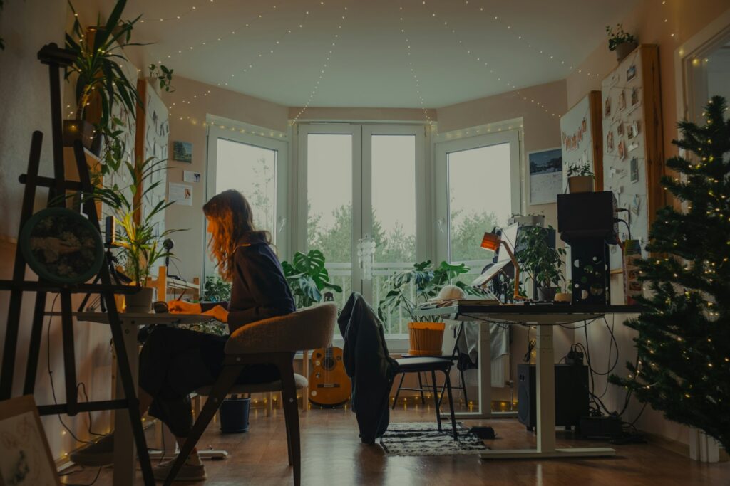 Therapist working at a cozy, plant-filled desk researching AI search for her practice
