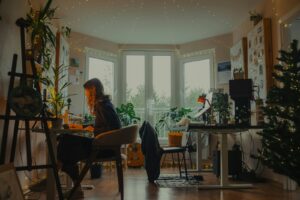 Therapist working at a cozy, plant-filled desk researching AI search for her practice
